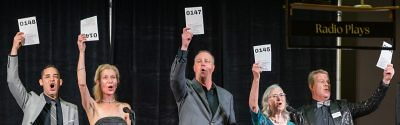 Performers at Gala Holding Up Auction Bidding Numbers